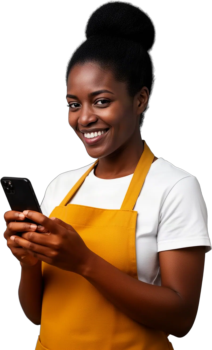 A smiling woman in a mustard-yellow apron over a white t-shirt holding a smartphone in both hands.